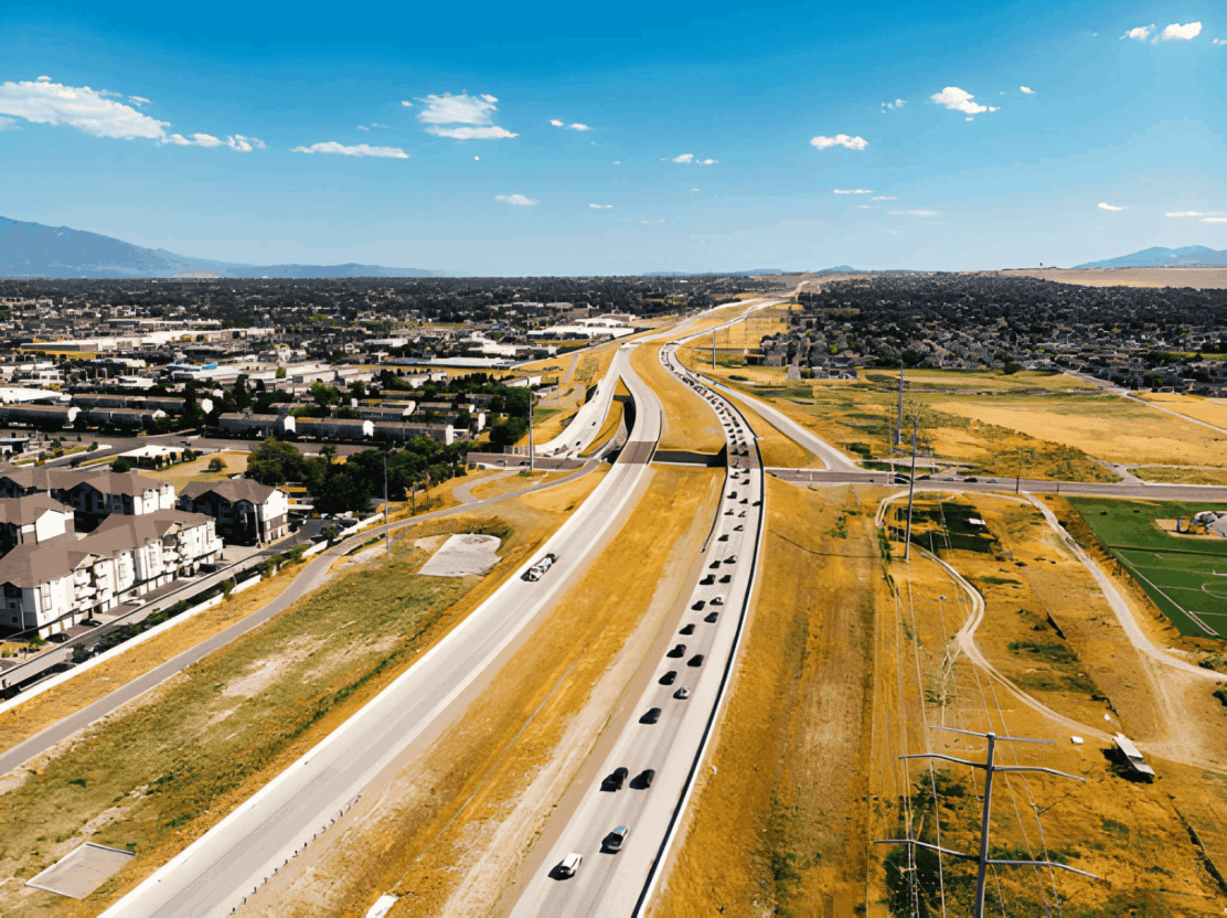 Highway winding through a sprawling suburban area.